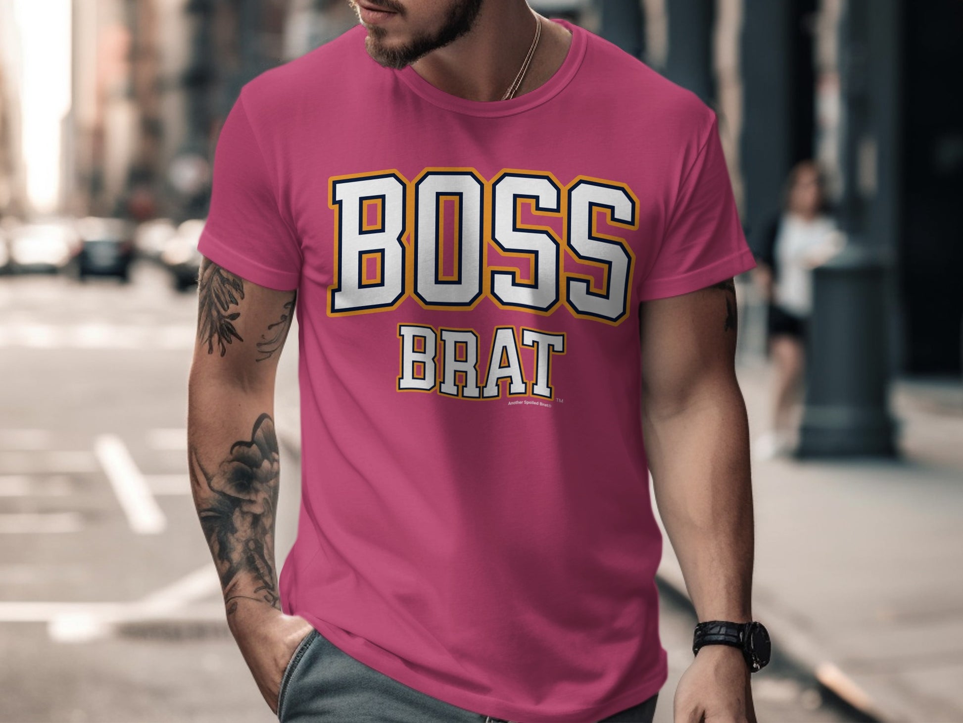 Pink t-shirt with white and yellow text that reads "BOSS BRAT".