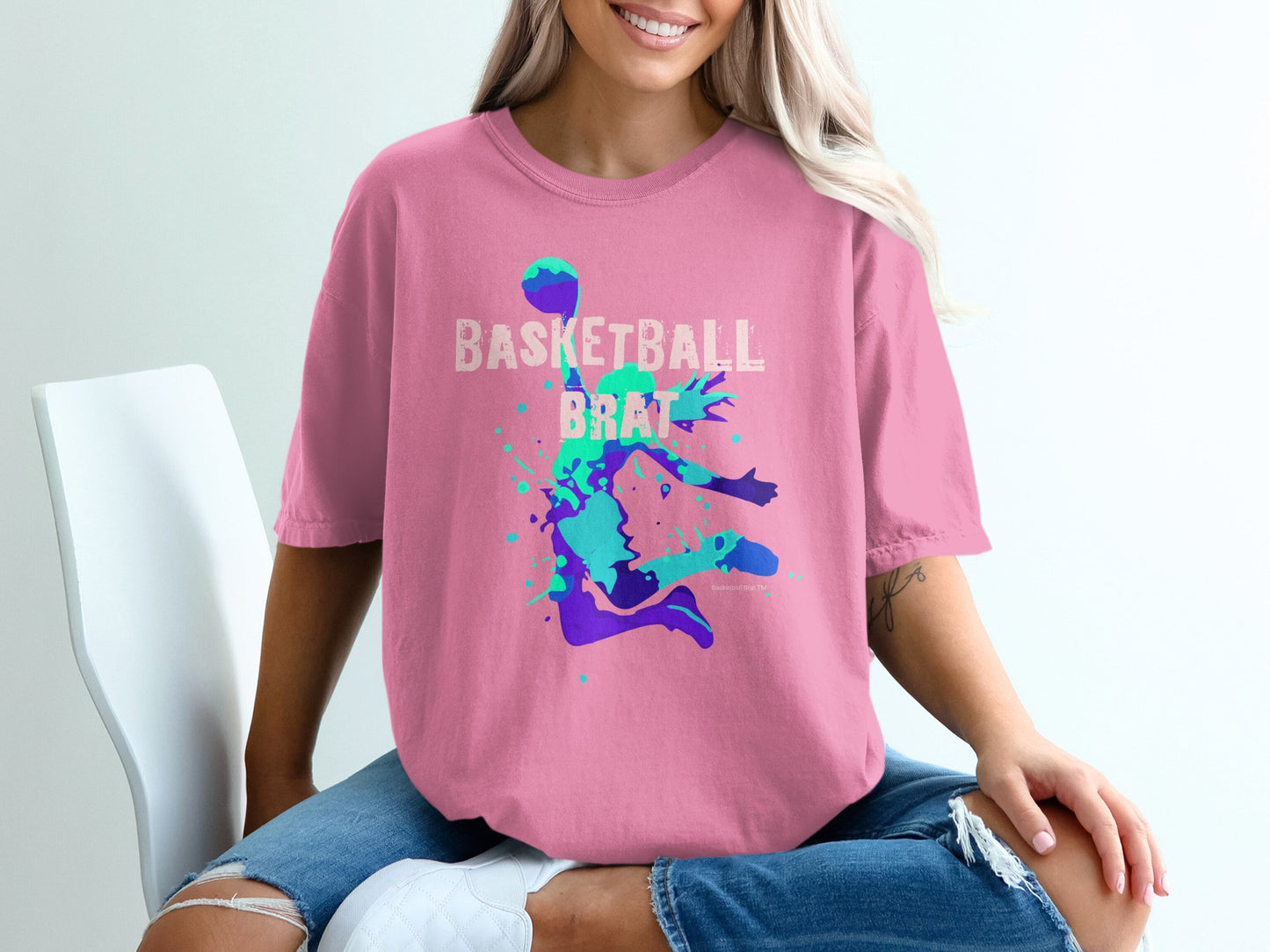 Pink t-shirt with a basketball player graphic and the words "Basketball Brat".