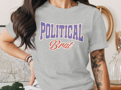 Grey t-shirt with "POLITICAL Brat" text in blue and red lettering.