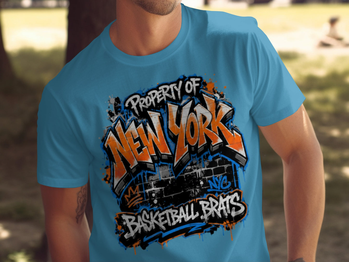 Blue t-shirt with "Property of New York Basketball Brats" graffiti design.