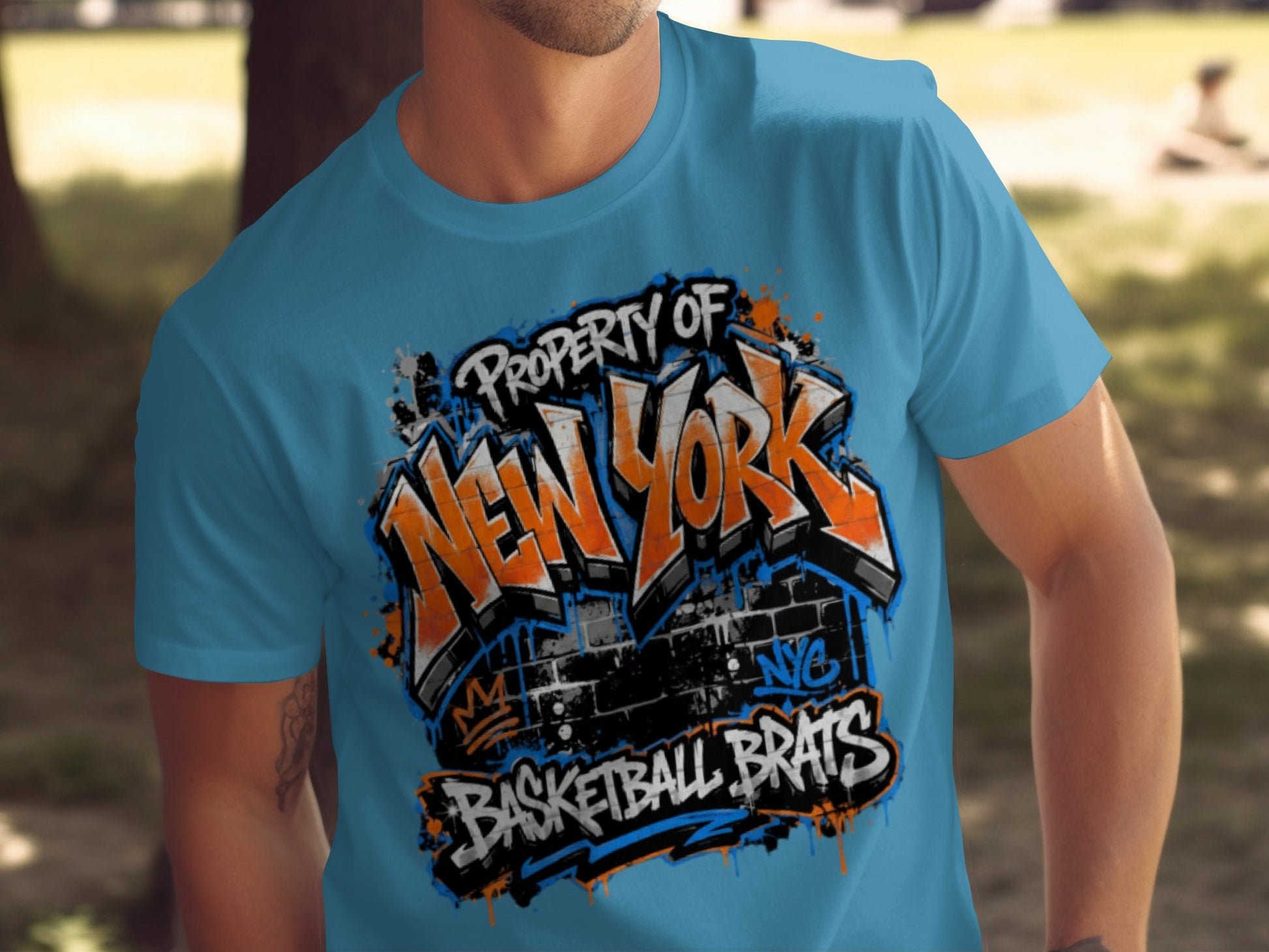 Blue t-shirt with "Property of New York Basketball Brats" graffiti design.