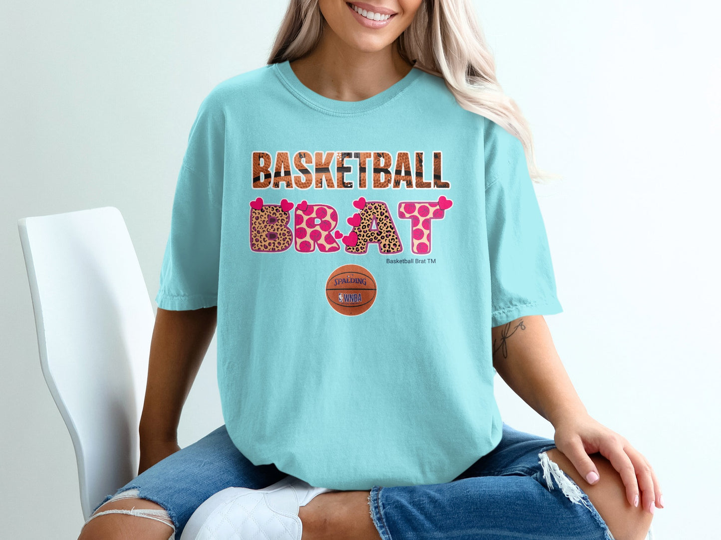 Light blue t-shirt with "BASKETBALL BRAT" in leopard print and a basketball logo.