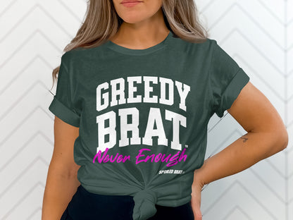 Dark green t-shirt with "GREEDY BRAT" and "Never Enough" text.