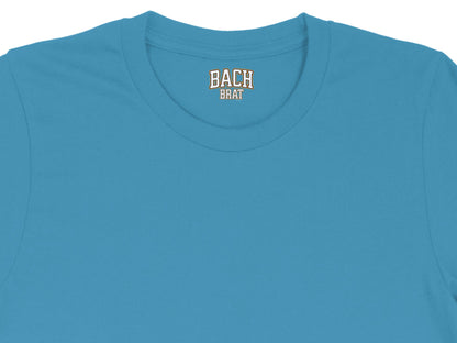 Turquoise t-shirt with "BACH BRAT" graphic on the neck tag.