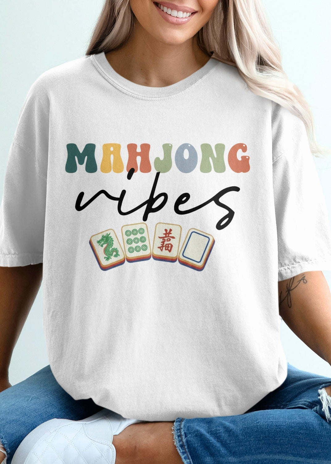 White t-shirt with "Mahjong vibes" text and Mahjong tiles.