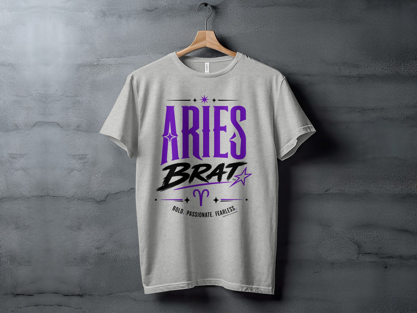 Grey t-shirt with "Aries Brat" in purple and black, Aries symbol, and text.