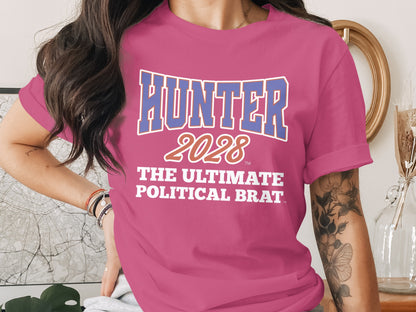 Pink t-shirt with blue "HUNTER 2028 THE ULTIMATE POLITICAL BRAT" text.