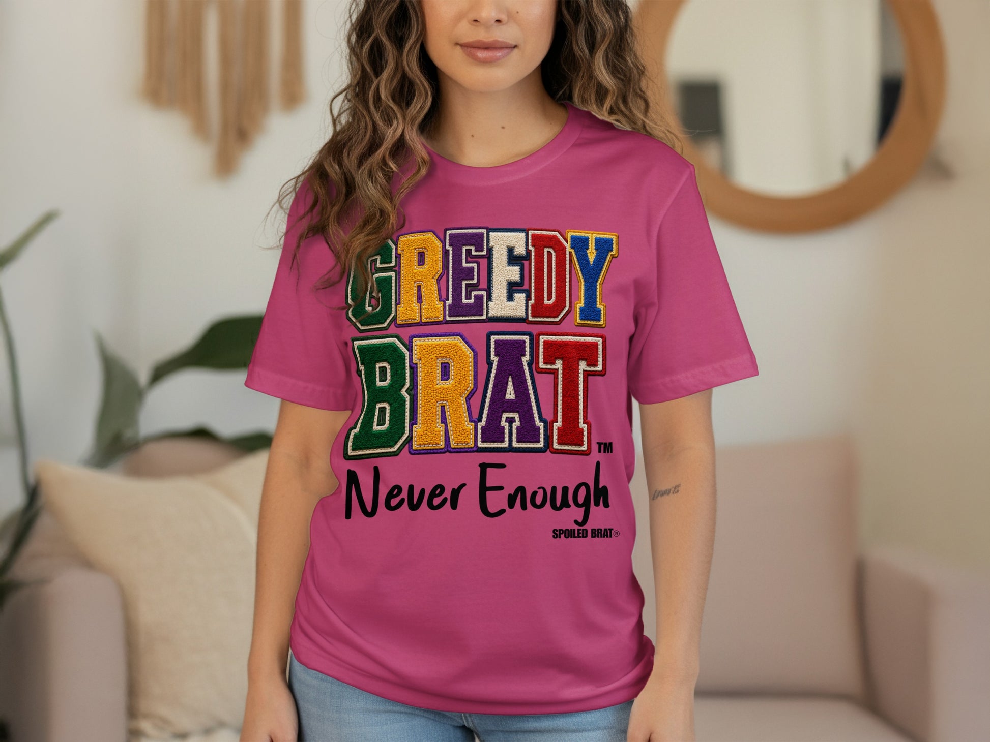 Pink t-shirt with "GREEDY BRAT Never Enough" text and Spoiled Brat logo.