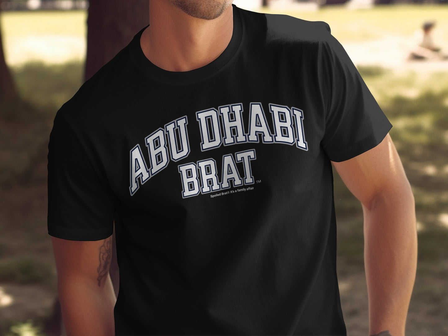Black t-shirt with white text "ABU DHABI BRAT".