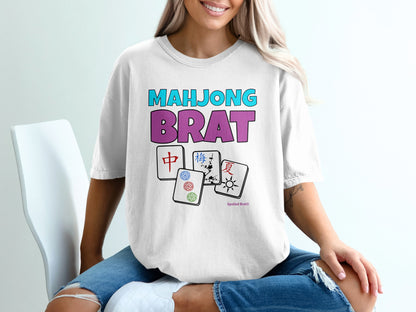 White t-shirt with "Mahjong Brat" text and Mahjong tile graphics.
