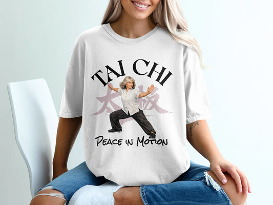 Woman in white t-shirt with "Tai Chi Peace in Motion" text and illustration.