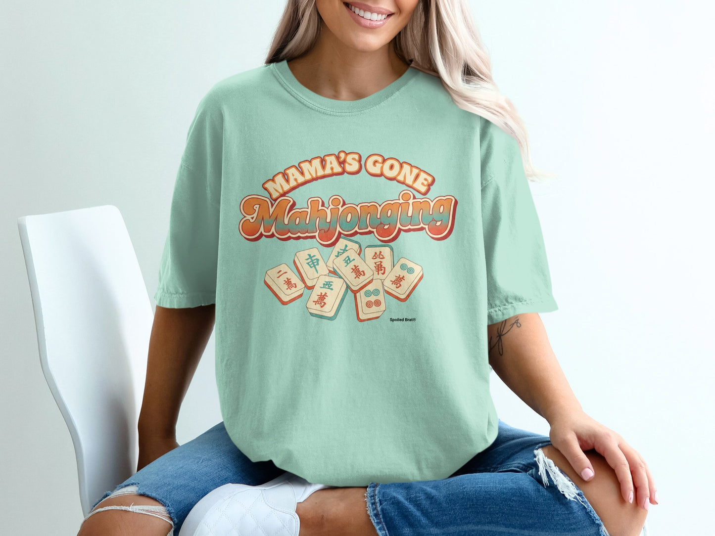 Mint green t-shirt with "Mama's Gone Mahjong" text and mahjong tiles.