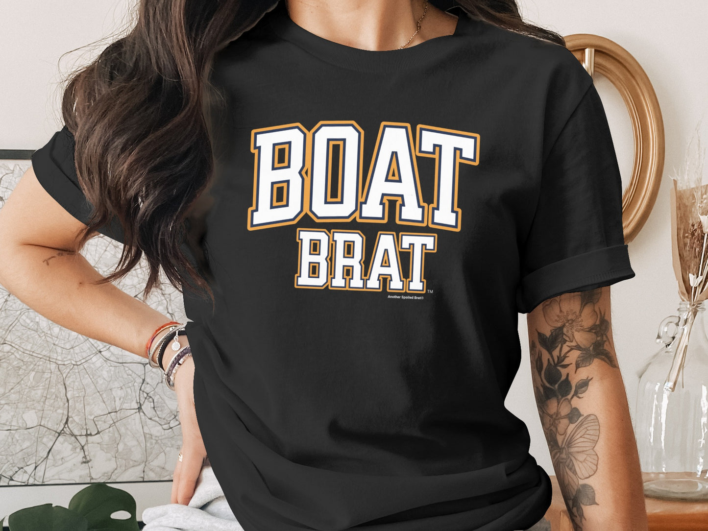Black t-shirt with "BOAT BRAT" text in collegiate-style lettering.
