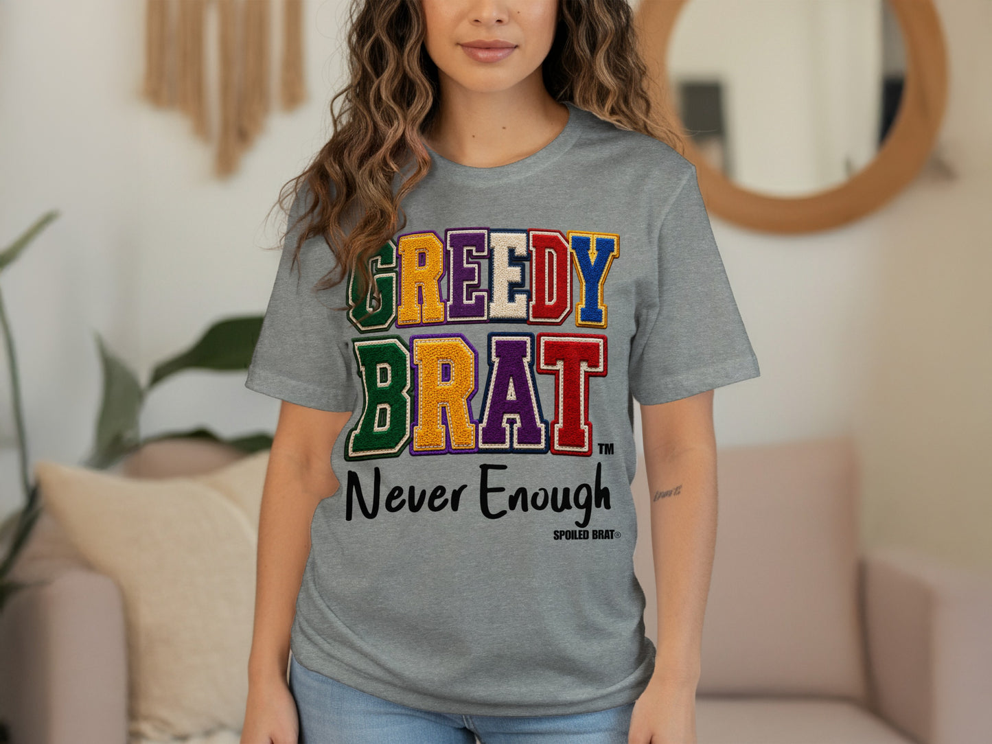 Grey t-shirt with "GREEDY BRAT Never Enough" text and Spoiled Brat logo.