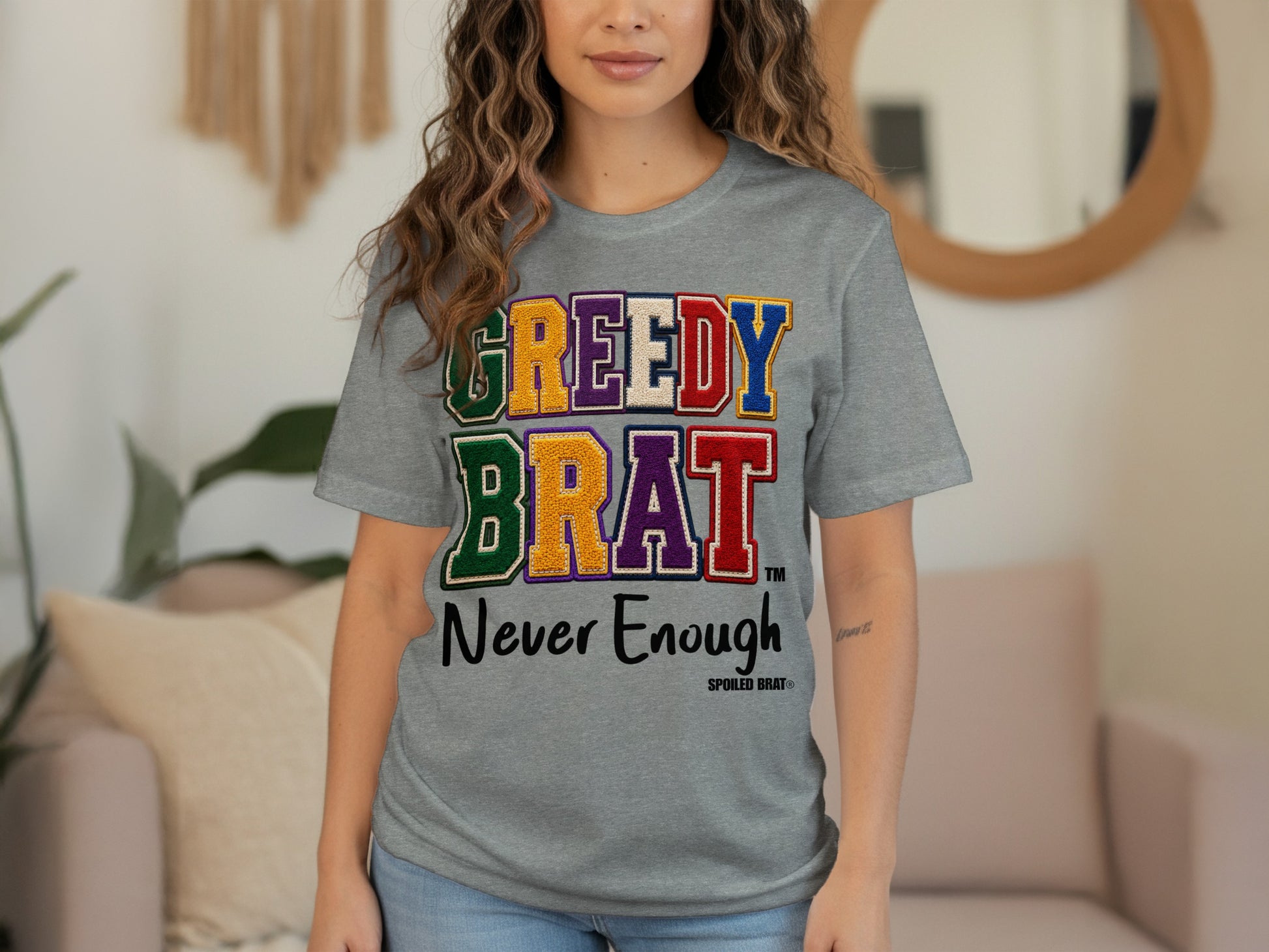 Grey t-shirt with "GREEDY BRAT Never Enough" text and Spoiled Brat logo.