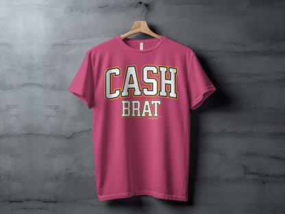 Pink t-shirt with white and gold "CASH BRAT" text in collegiate font.