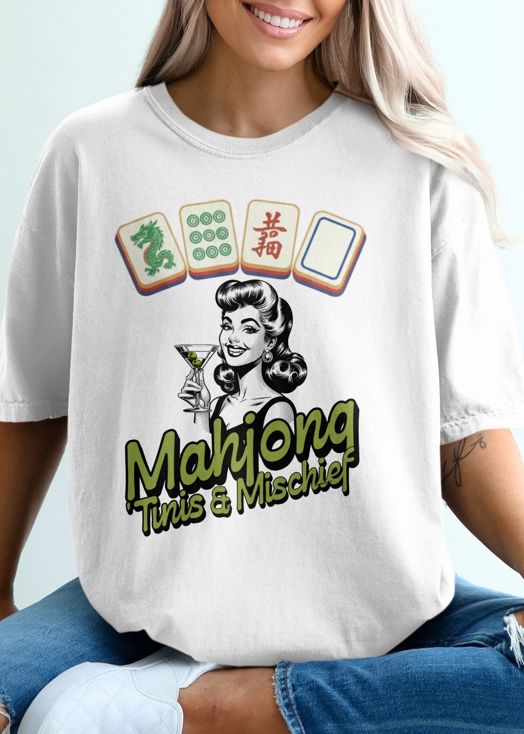 White t-shirt with vintage pin-up art and "Mahjong This & Mischief" text.