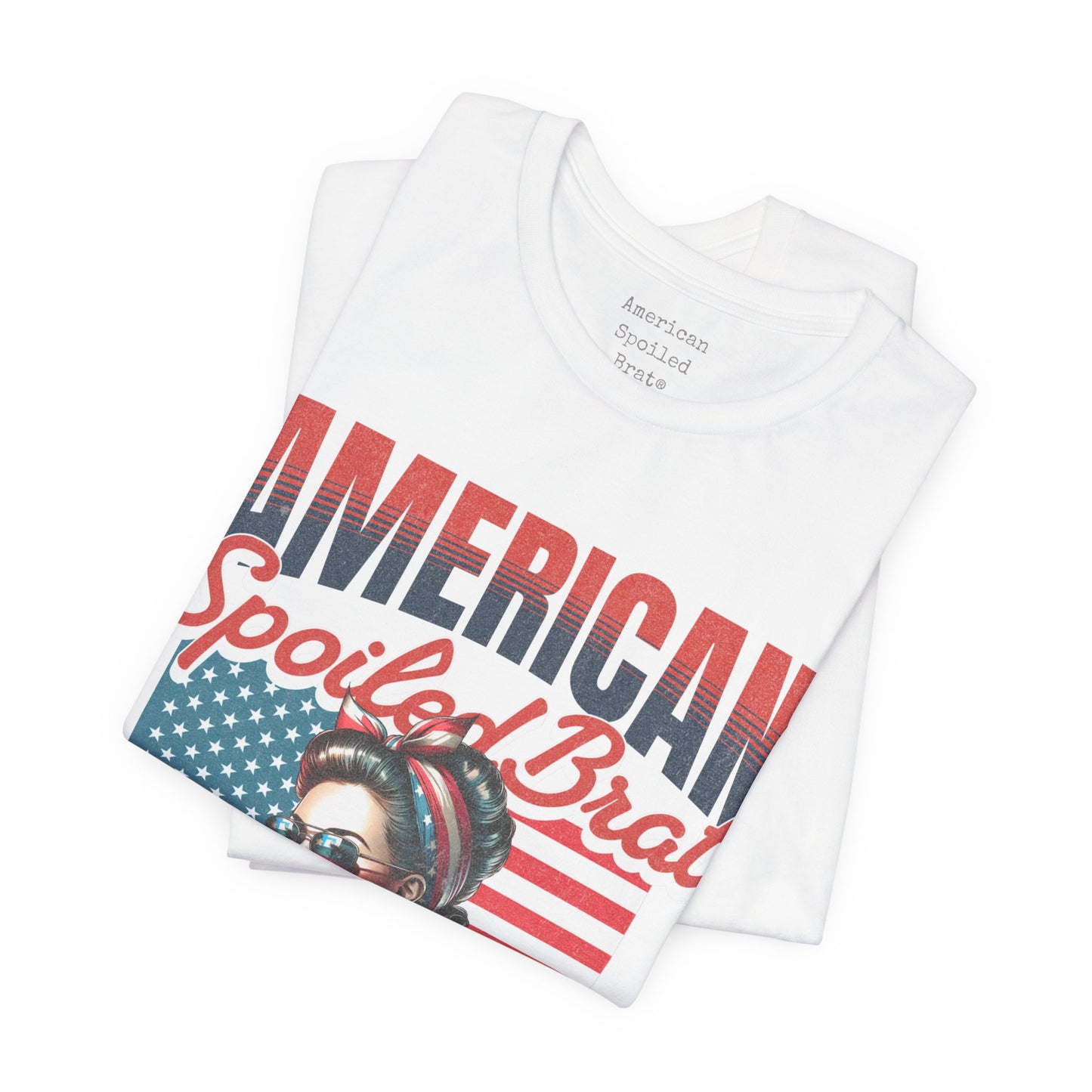 White t-shirt with "American Spoiled Brat" text and patriotic headband woman graphic.