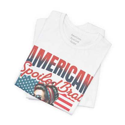 White t-shirt with "American Spoiled Brat" text and patriotic headband woman graphic.