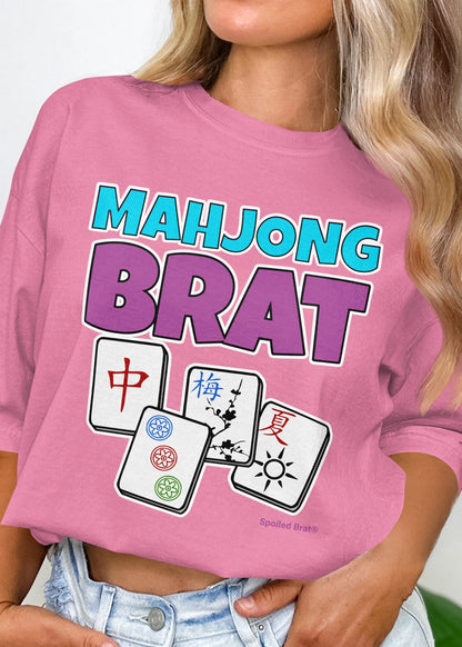 Pink t-shirt with "Mahjong Brat" and three Mahjong tiles.