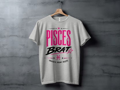 Light gray t-shirt with "PISCES BRAT" and Pisces zodiac symbol in pink and black.