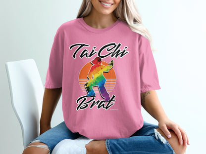 Pink t-shirt with "Tai Chi Brat" and rainbow-colored silhouette of a person practicing Tai Chi.