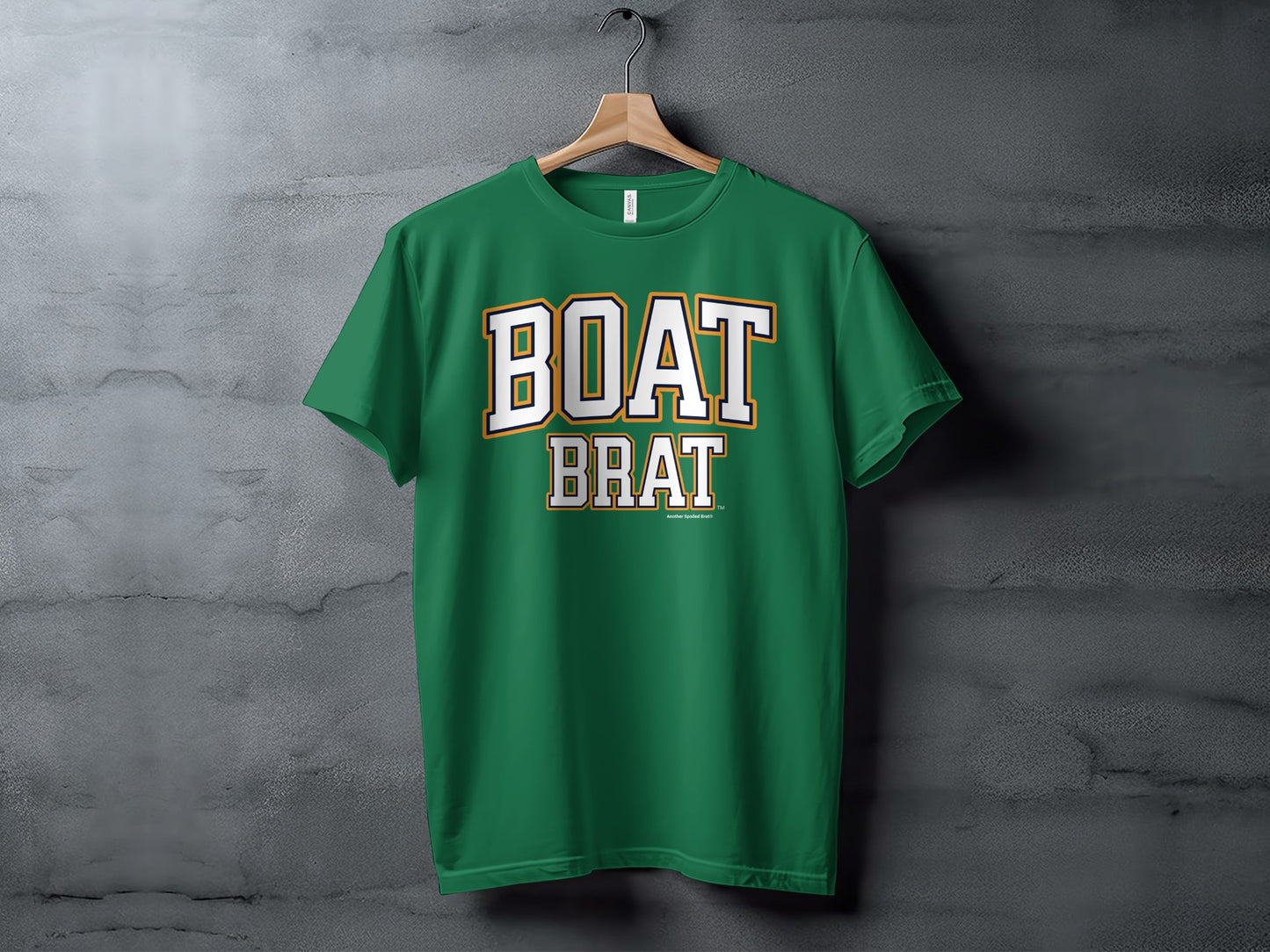 Green t-shirt with white and gold "BOAT BRAT" text centered on the chest.