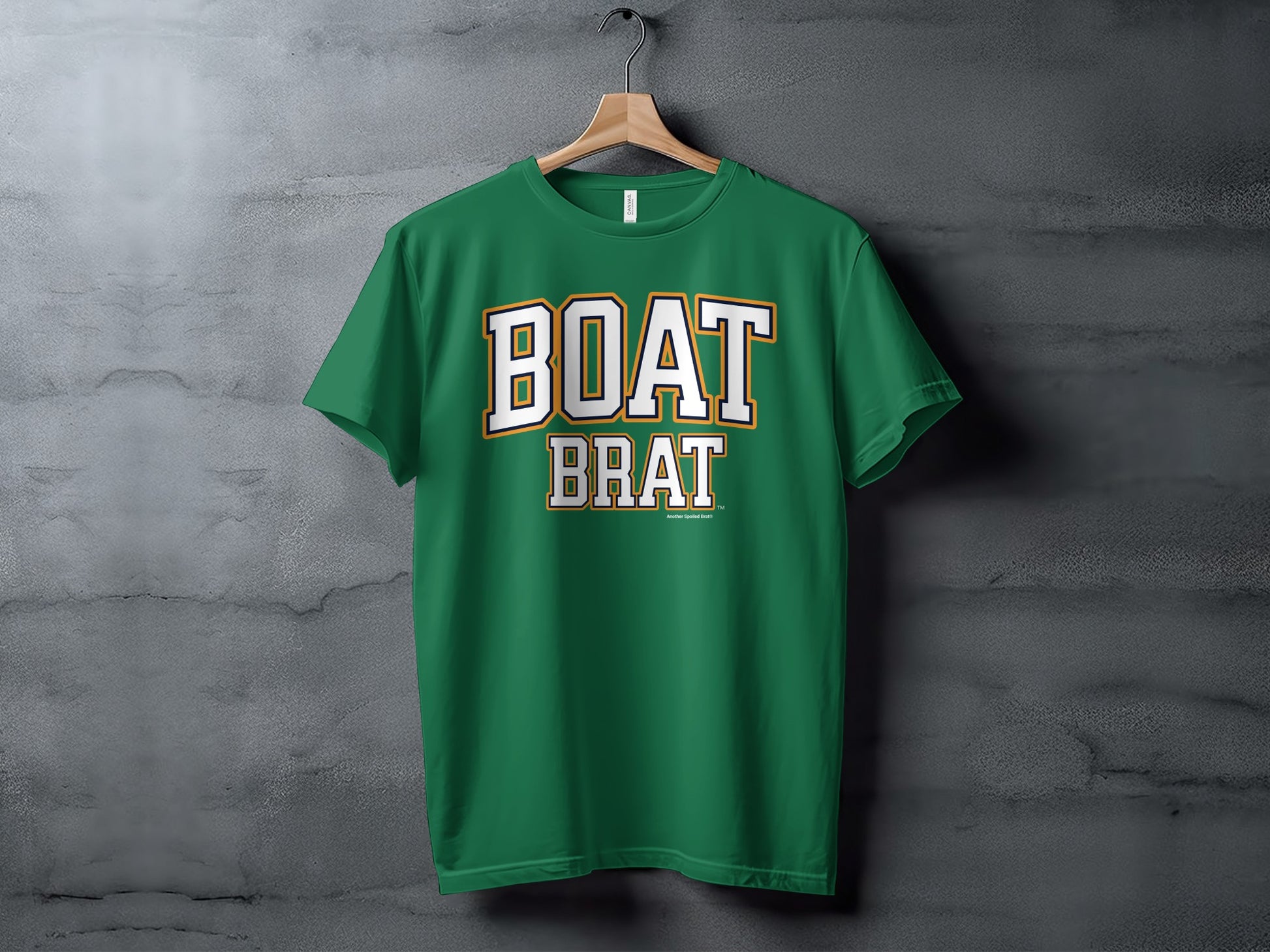 Green t-shirt with white and gold "BOAT BRAT" text centered on the chest.