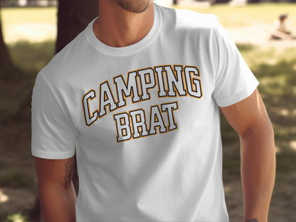 White t-shirt with "CAMPING BRAT" text in collegiate font outdoors.