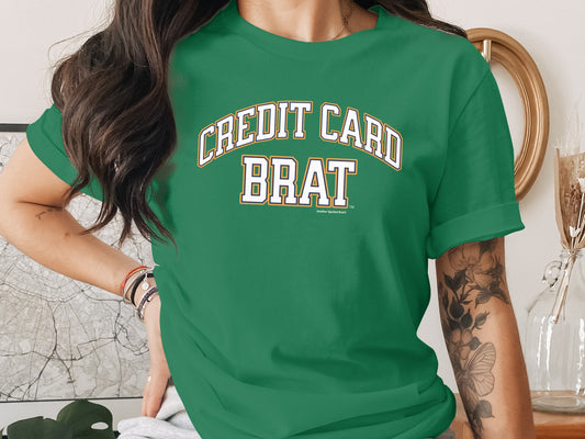 Green t-shirt with "CREDIT CARD BRAT" text in varsity lettering.