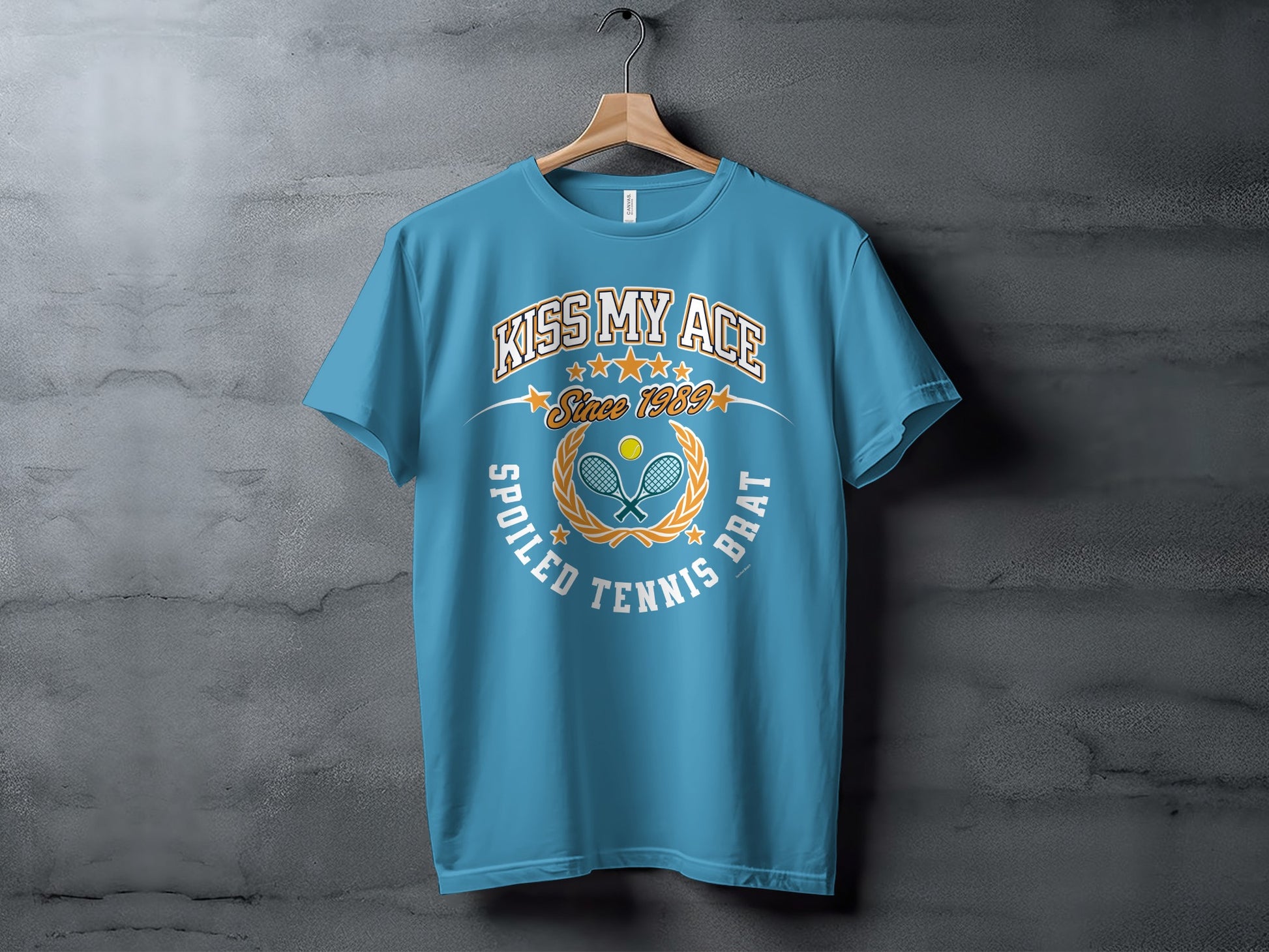 T-shirt with "Kiss My Ace Since 1989 Spoiled Tennis Brat" text and tennis imagery.