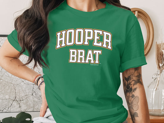 Green t-shirt with "HOOPER BRAT" text in white and gold lettering.