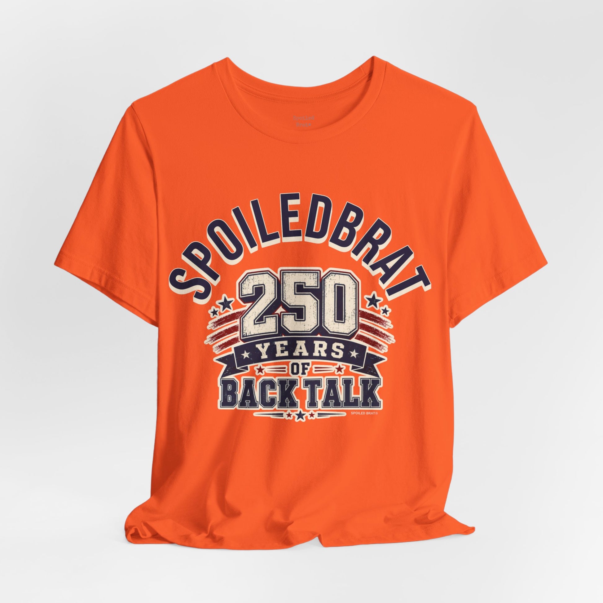 Orange t-shirt with "Spoiled Brat 250 Years of Back Talk" design.
