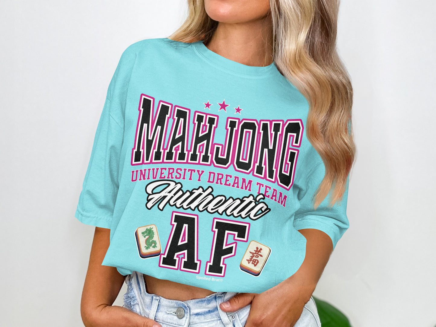 Turquoise t-shirt with "Mahjong University Dream Team Authentic AF" text and tile graphics.