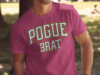 Man wearing pink t-shirt with "POGUE BRAT" in white block letters.