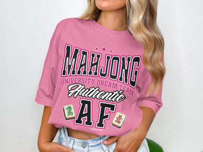 Pink t-shirt with "Mahjong University Dream Team Authentic AF" and mahjong tiles.