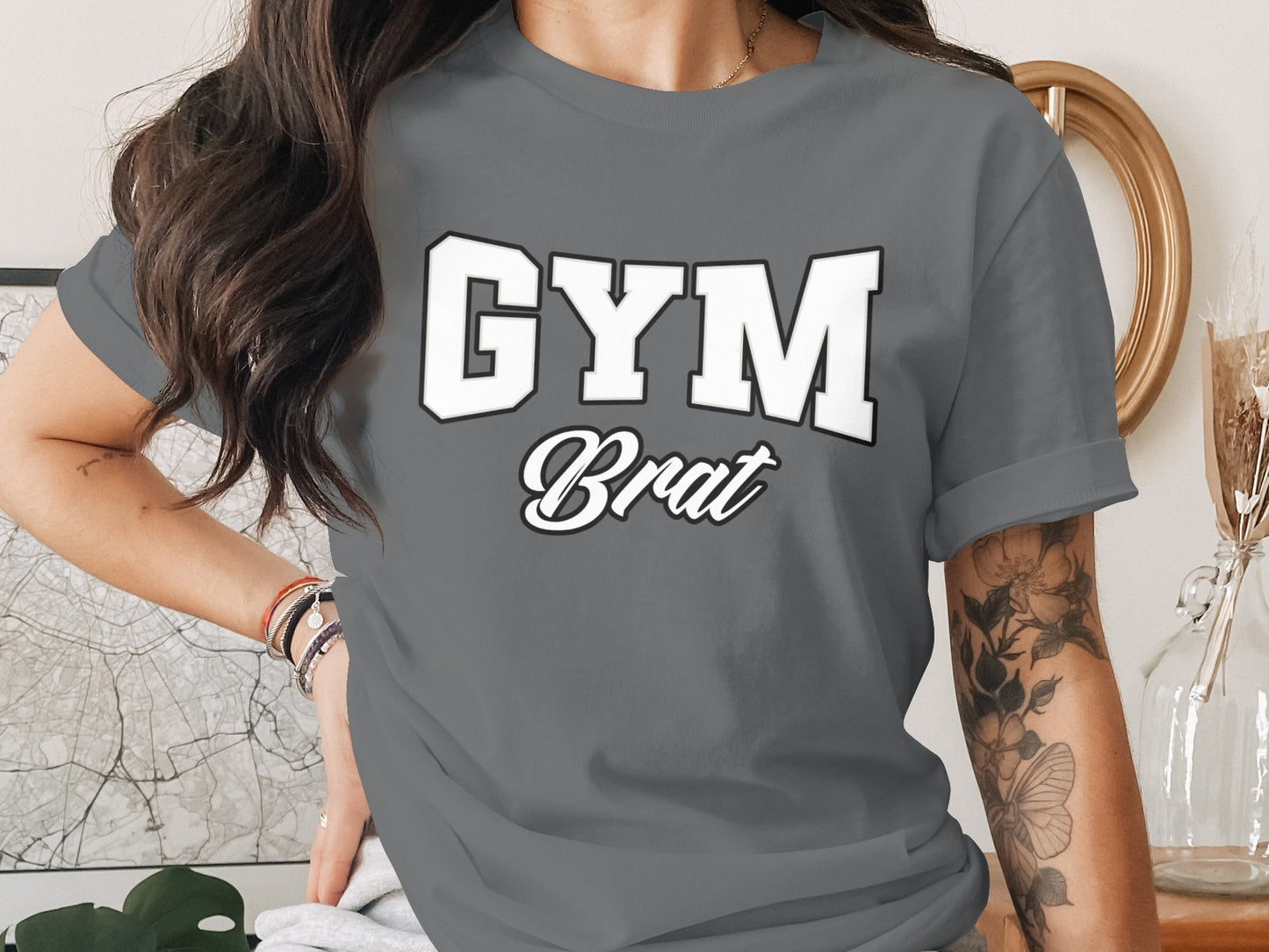 Gray t-shirt with white and black text reading "GYM Brat".