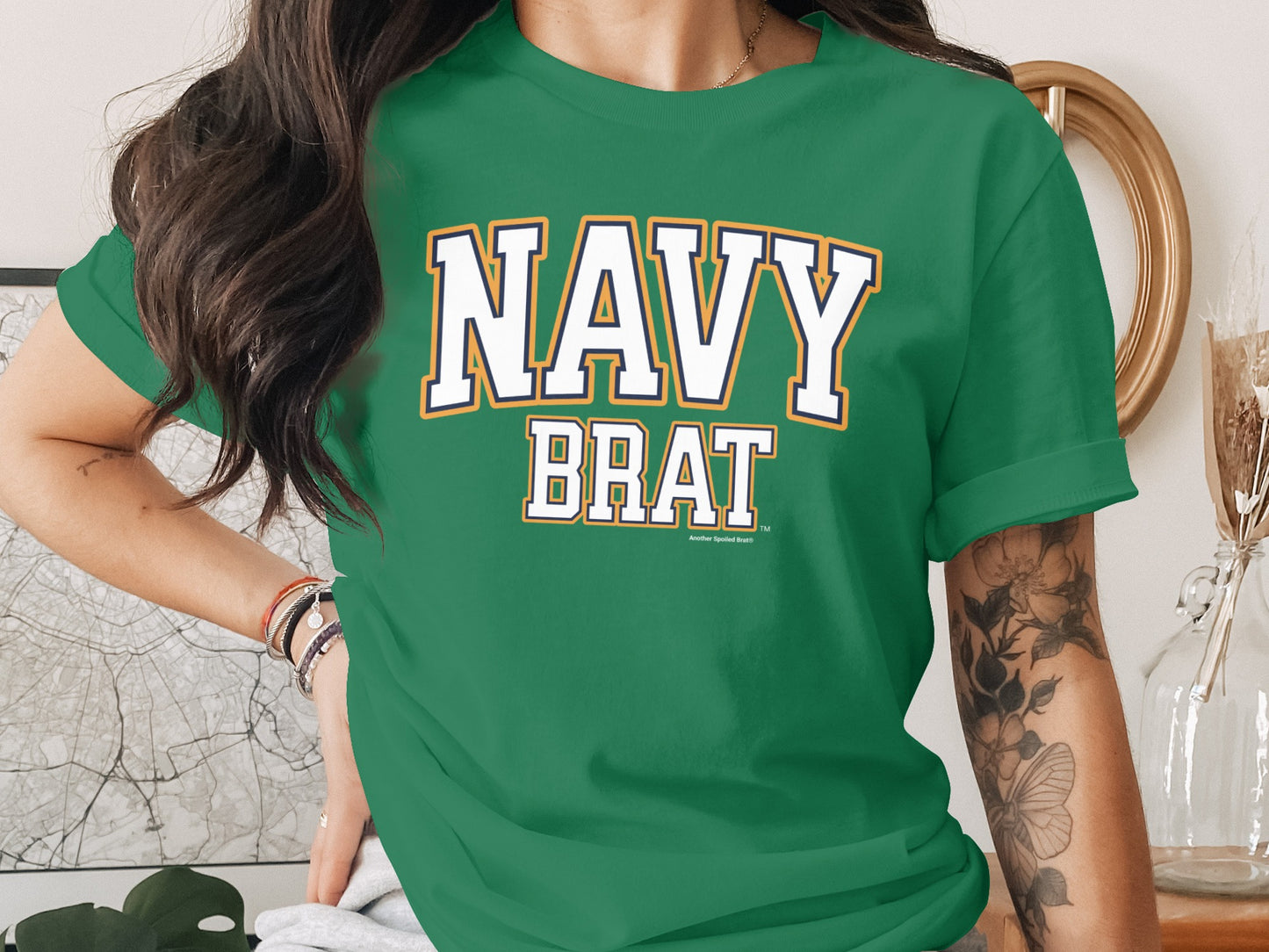 Green t-shirt with "NAVY BRAT" text in white with blue and yellow trim.
