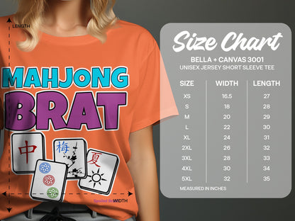 Orange t-shirt with "MAHJONG BRAT" text and mahjong tiles, with a size chart.