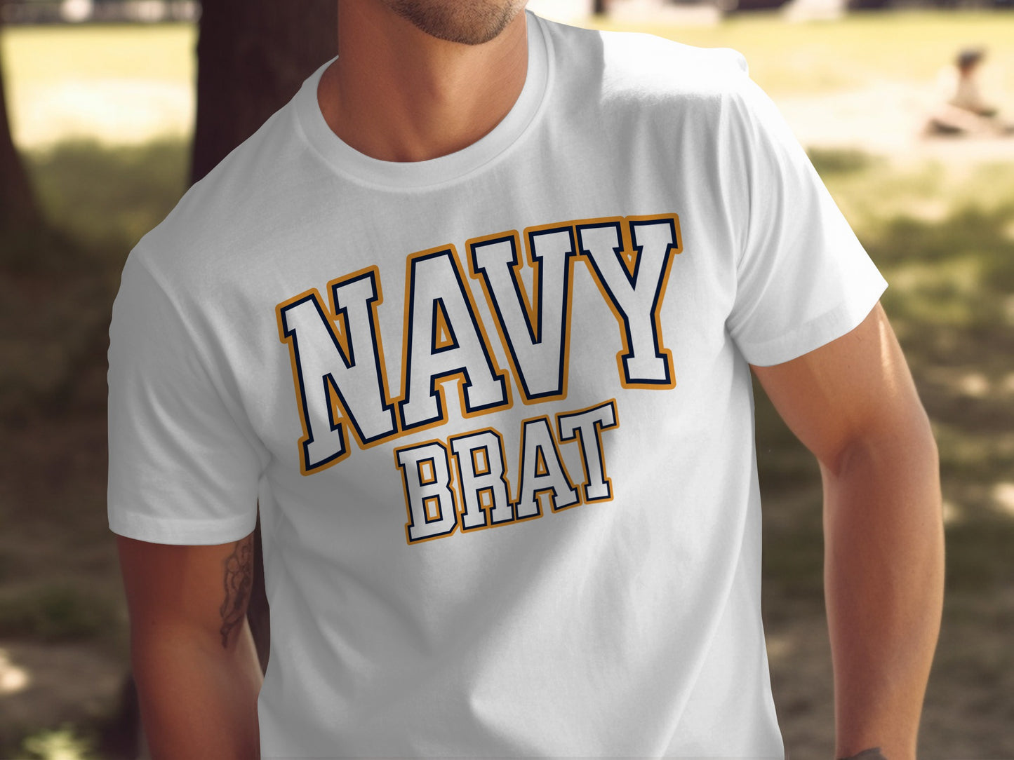 White t-shirt with "NAVY BRAT" text in blue and orange outline letters.