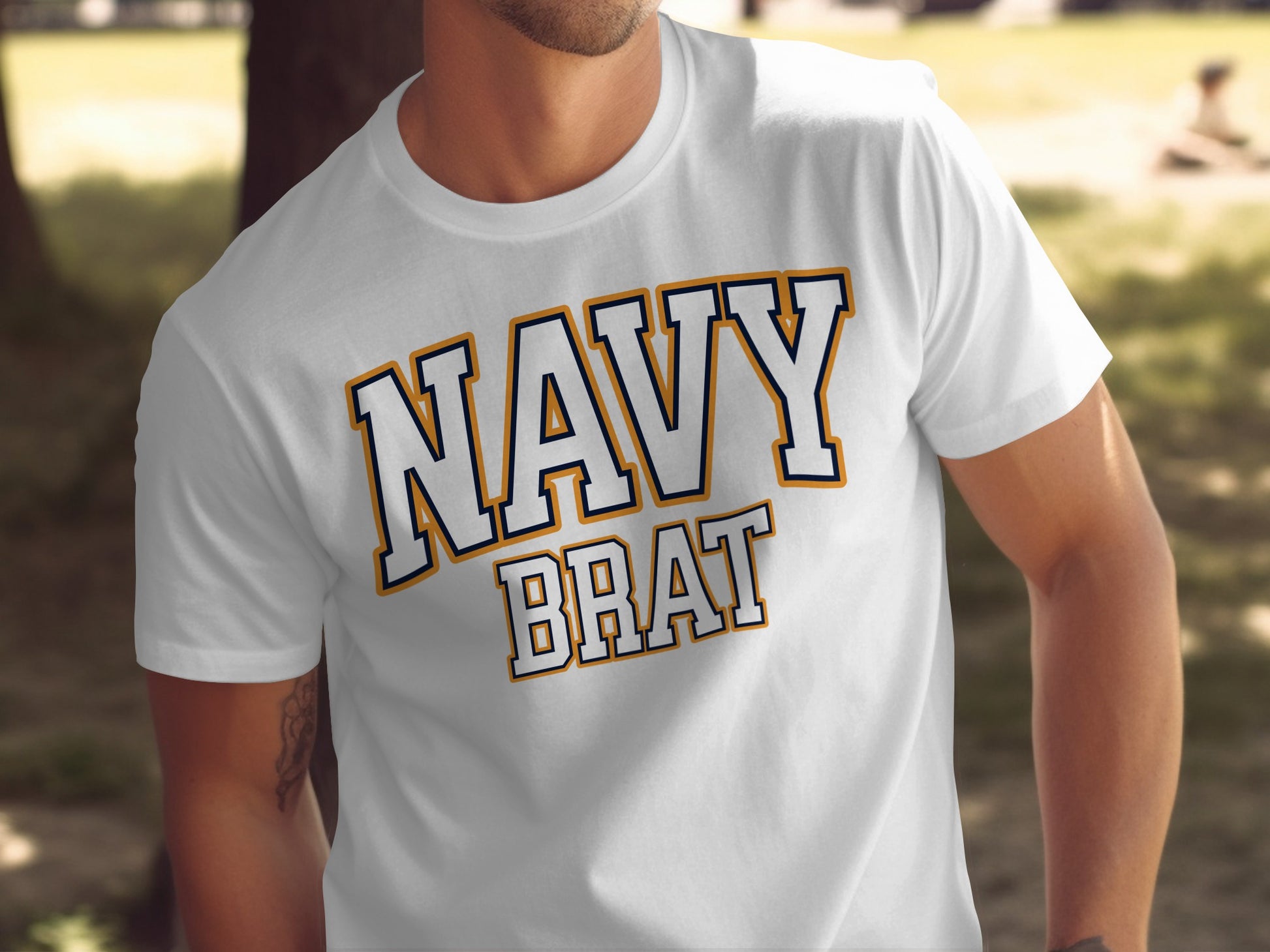 White t-shirt with "NAVY BRAT" text in blue and orange outline letters.