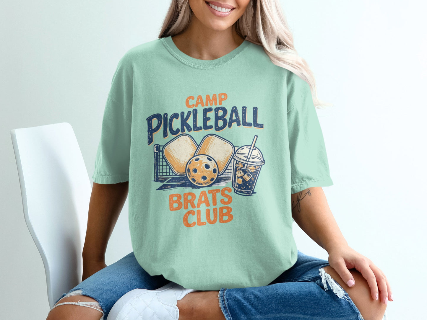 Camp Pickleball Brats Club graphic tee with pickleball paddles, ball, and drink.