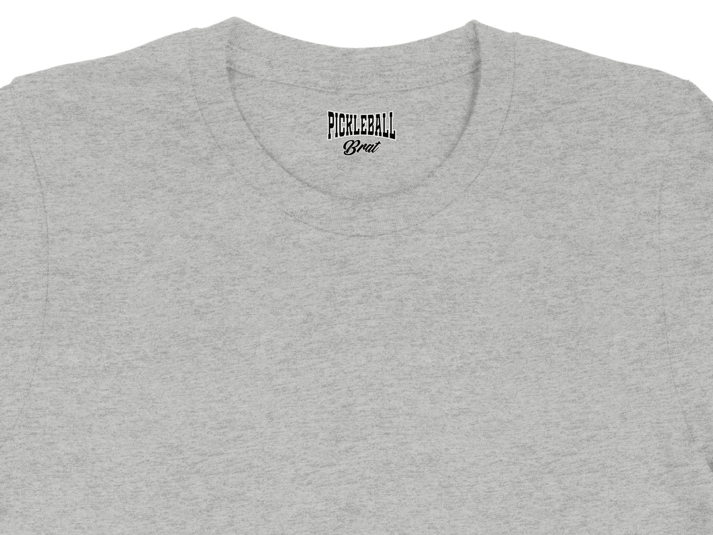 Grey t-shirt with black text that says "PICKLEBALL Brat" on the collar.