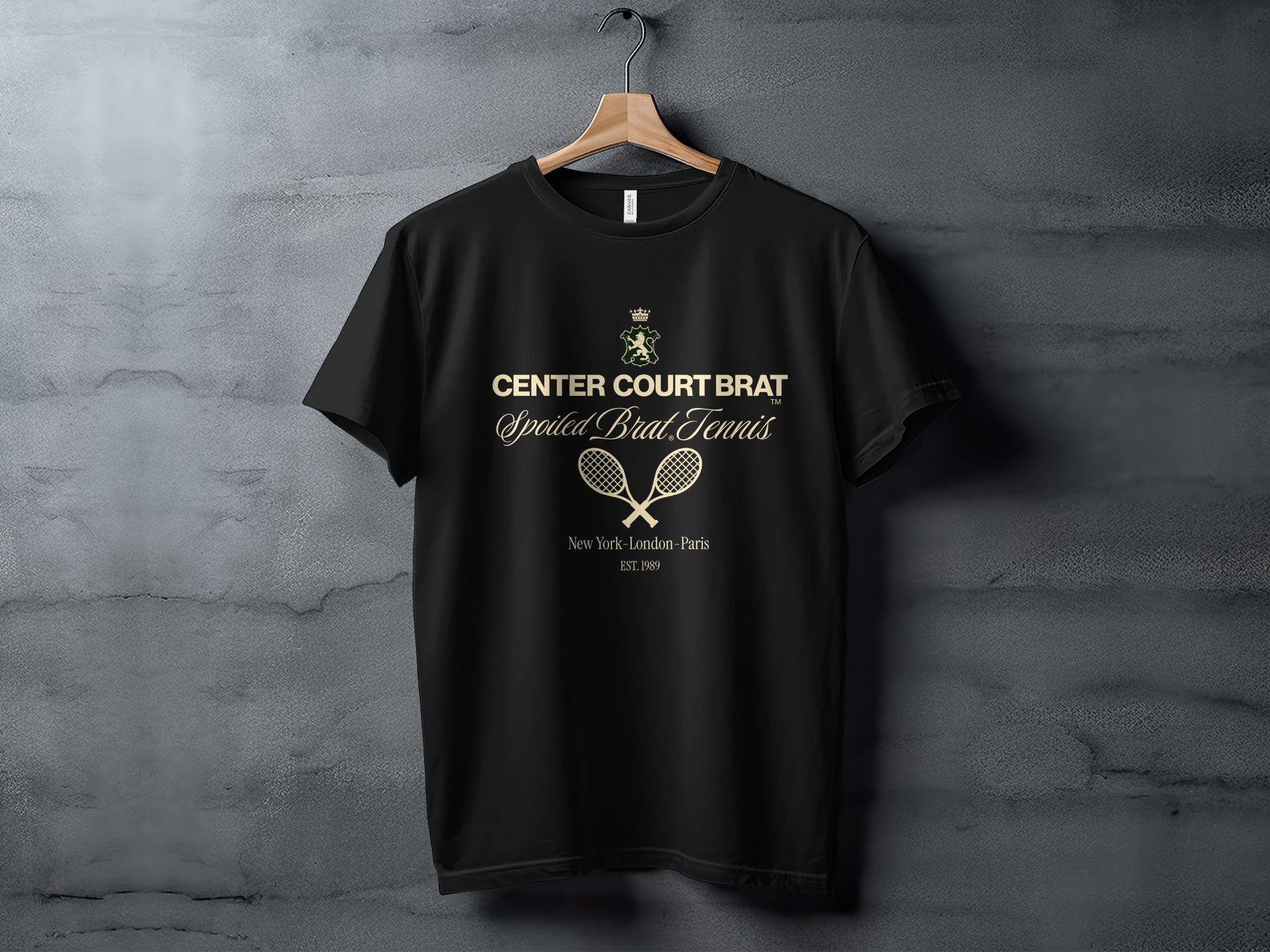 Black t-shirt with gold text "CENTER COURT BRAT Spoiled Brat Tennis" and tennis rackets.