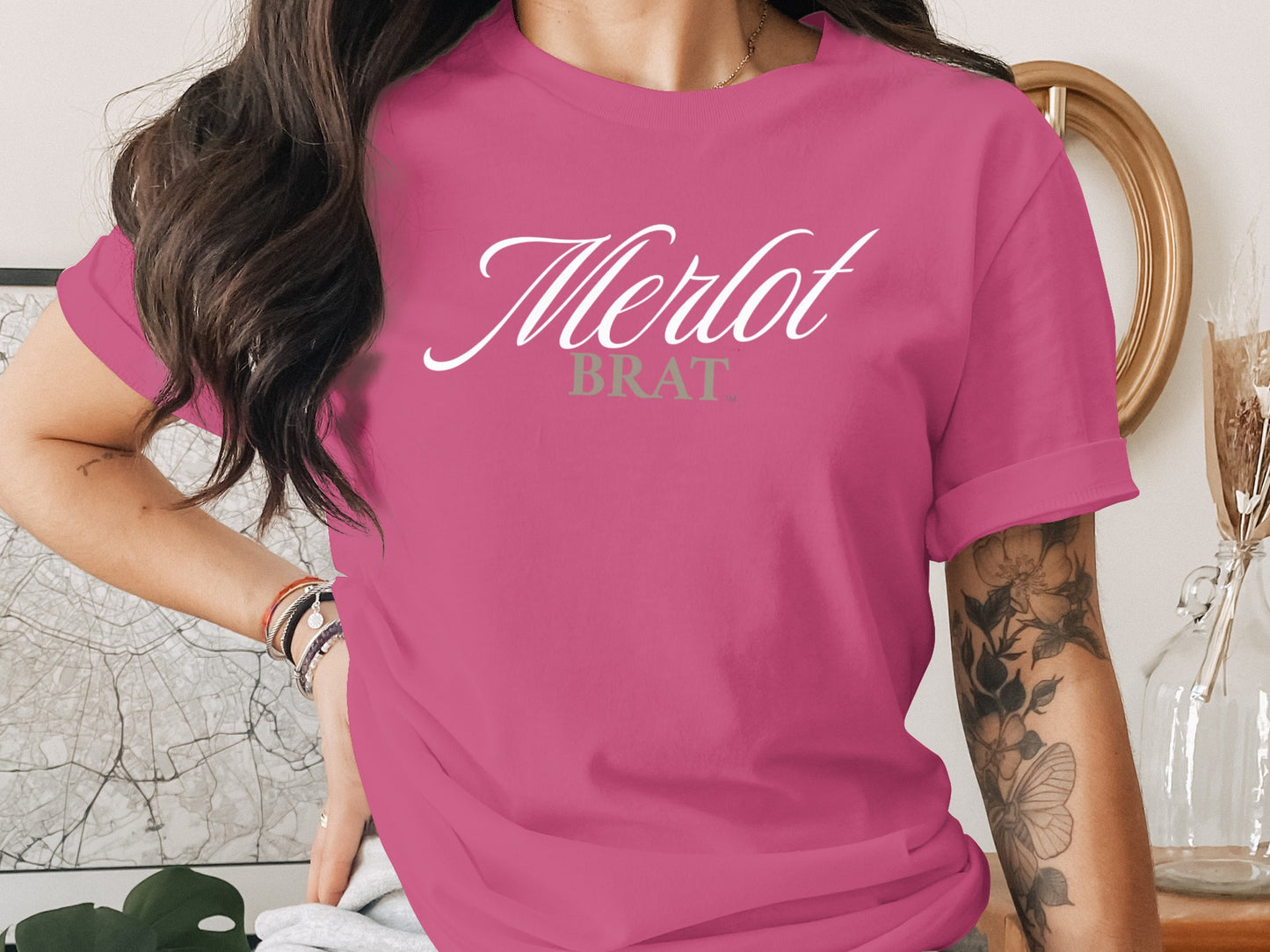 Pink t-shirt with white "Merlot" and green "BRAT" text.