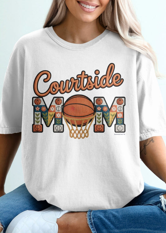 White t-shirt with "Courtside Mom" text and basketball graphics.