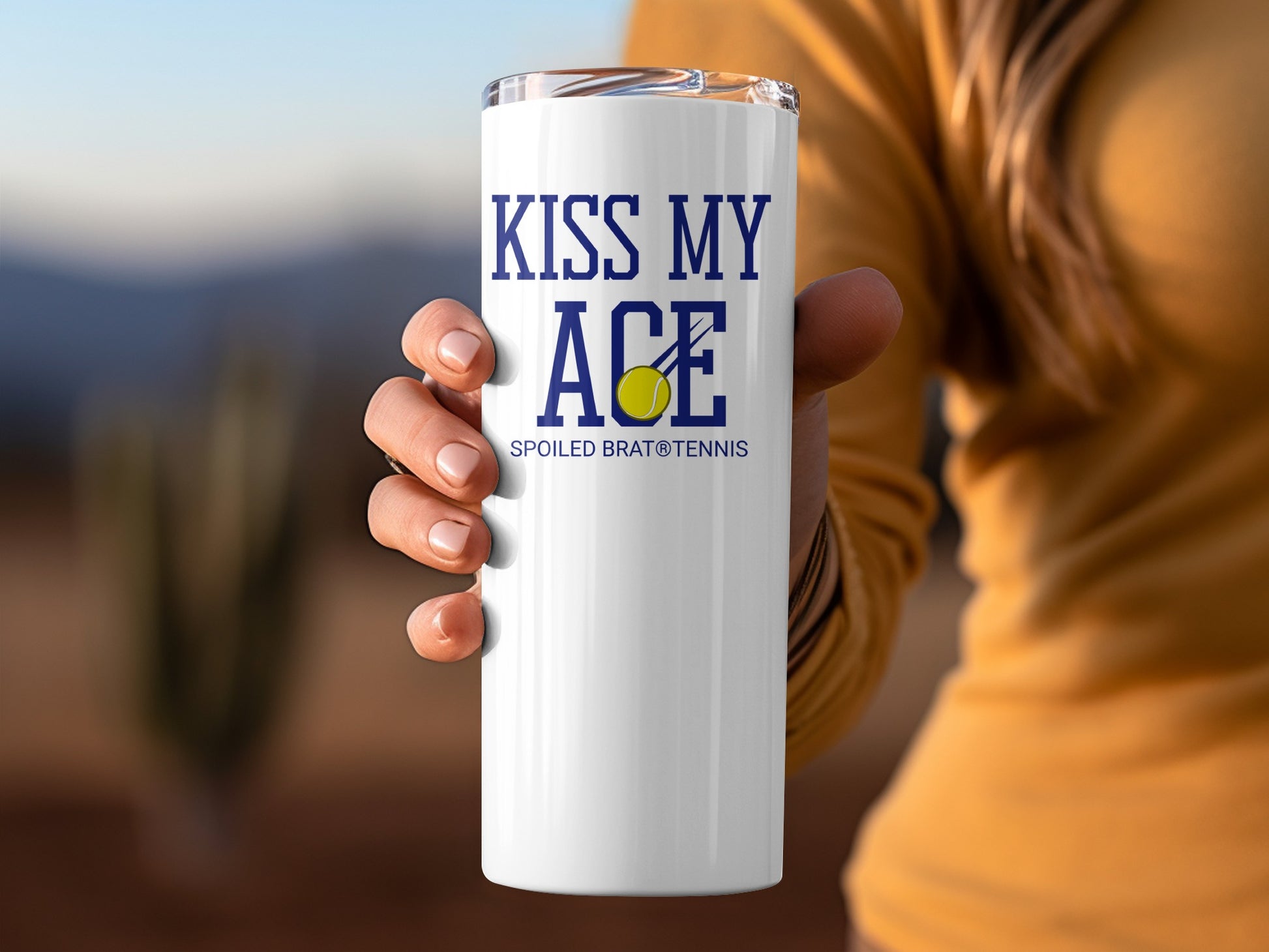 White tumbler with "Kiss My Ace" and "Spoiled Brat Tennis" text, and a tennis ball.