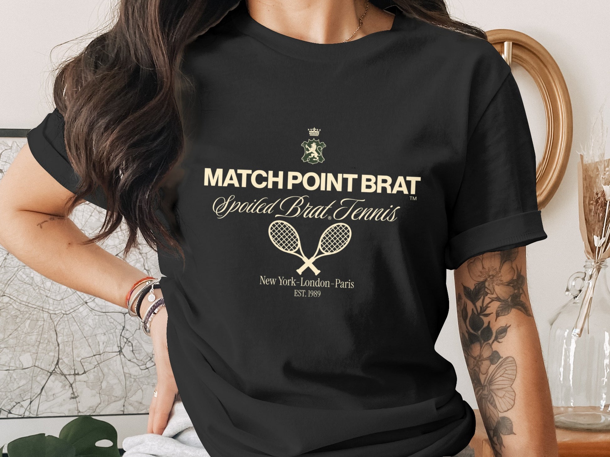 Black t-shirt with "Match Point Brat Spoiled Brat Tennis" text and crossed rackets.