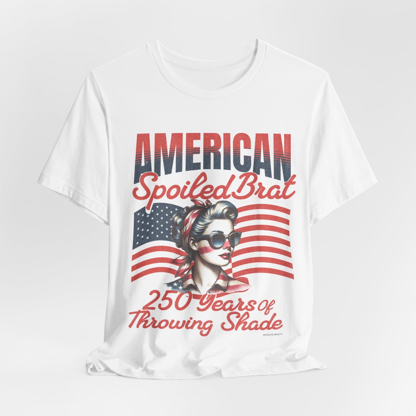 White t-shirt with "AMERICAN Spoiled Brat" and retro woman graphic.