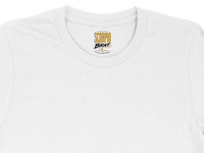White t-shirt neck tag with "Scorpio Brat" and descriptive text.